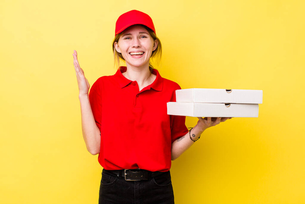 red head pretty woman feeling happy, surprised realizing a solution or idea. delivery pizza concept - 写真・画像