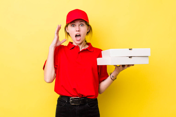red head pretty woman screaming with hands up in the air. delivery pizza concept - Φωτογραφία, εικόνα
