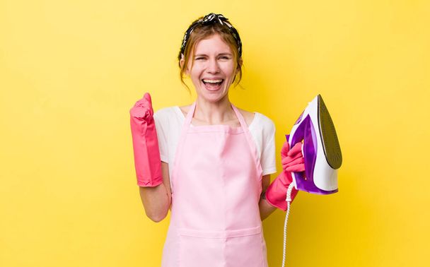 red head pretty woman feeling shocked,laughing and celebrating success. housekeeper concept - 写真・画像