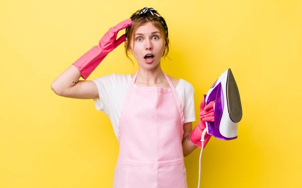 red head pretty woman looking happy, astonished and surprised. housekeeper concept - 写真・画像