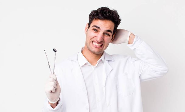 handsome hispanic man feeling stressed, anxious or scared, with hands on head. dentist concept - Fotografie, Obrázek