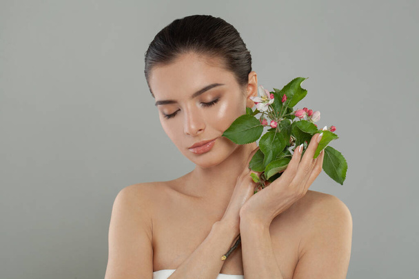 Portret van schattige schoonheid vrouwelijke vrouw volwassen met schone zuivere huid met roze bloem nemen spa ontspannen. Schoonheidsverzorging van de huid concept. Lichaamsdeel kale schouder - Foto, afbeelding