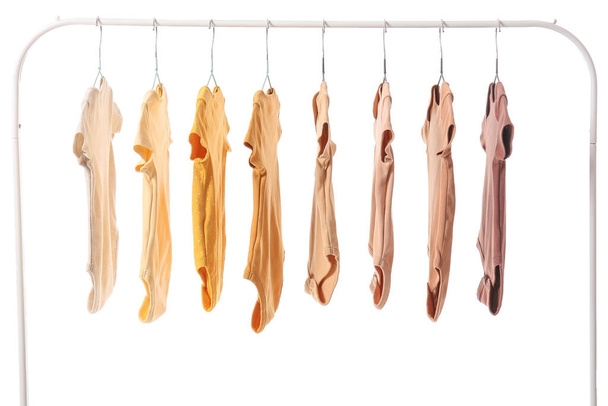 Rack with baby bodysuits on white background - Photo, Image
