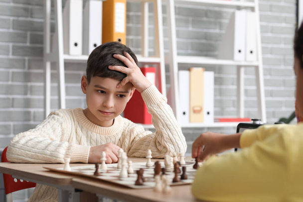Little children playing chess during tournament in club - Zdjęcie, obraz
