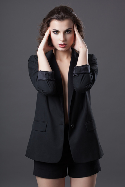 Fashion shoot of young woman in black jacket and shorts - Фото, зображення