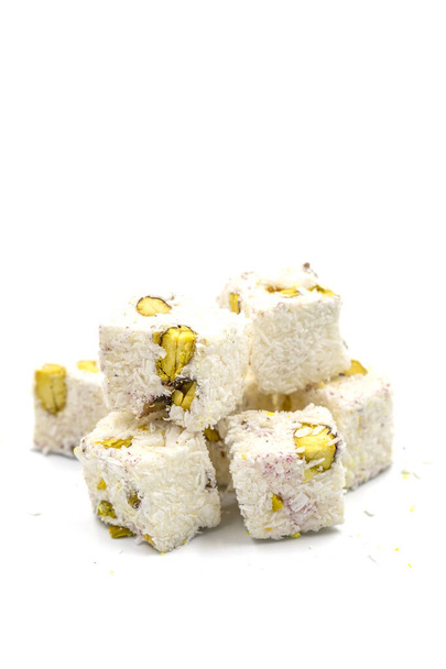 Turkish Delight Double Roasted Sultan Wick with Coconut Flakes, isolated on a white background. Close-up pistachio Turkish delight. Traditional Turkish cuisine delicacies. - Photo, Image