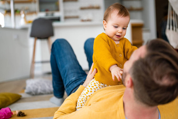 Father and daughter laughing and bonding. Daddy and his little girl spending time at home. Single dad fun love family lifestyle concept - 写真・画像