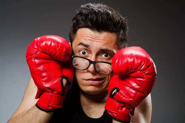 Funny boxer with red gloves against dark background - Foto, Imagen