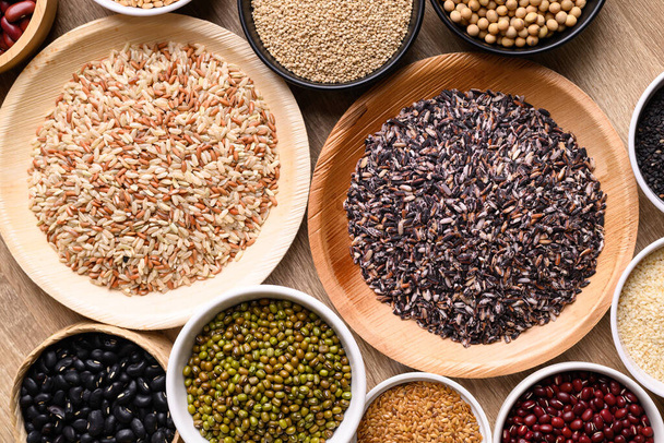 Various cereal, grain, bean, legume and seed in bowl on wooden background, Food ingredients, Table top view - Foto, Imagem