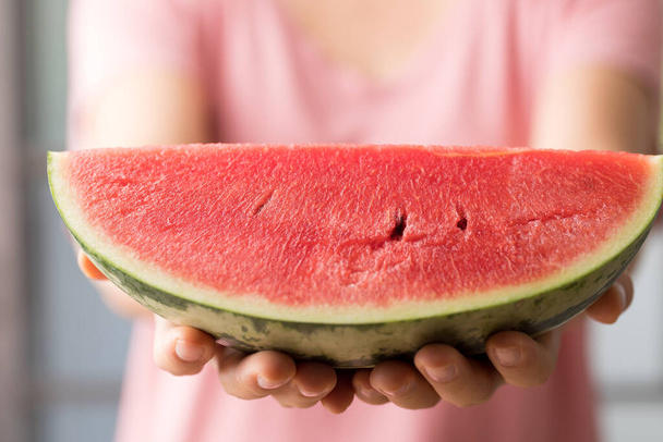 Sliced watermelon holding by womand hand, Tropical fruit in summer season - Zdjęcie, obraz