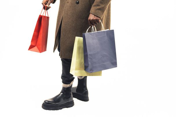 Man with shopping bags focus on the bags white background - close-up shot - 写真・画像