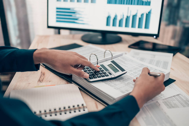 Investors working on desk office and using a calculator to calculate balance, projit, currency and cost. Accounting and  Financial concept. - Photo, Image