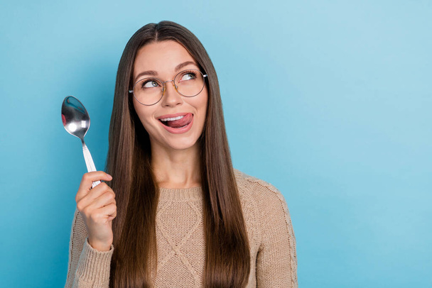 Portrait of attractive funny cheerful girl licking lip hold spoon copy space menu isolated over bright blue color background - Photo, image