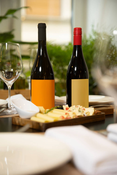 Wine mockup bottles served on a restaurant table - Valokuva, kuva