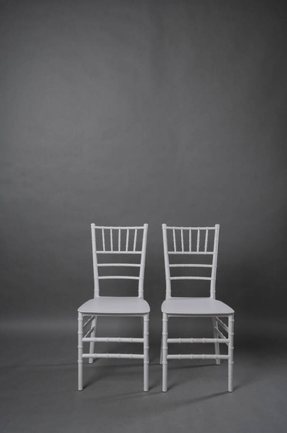two white chairs on grey backgroun - Fotoğraf, Görsel