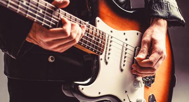 Musical instrument. Electric guitar. Repetition of rock music band. Music festival. Man playing guitar. Close up hand playing guitar. Musician playing guitar, live music - Zdjęcie, obraz