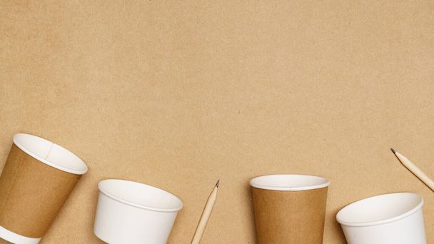 Eco friendly concept, Consist of paper cup and pencil with cotton buds on wooden background. - Photo, Image