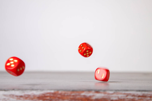 dice have fallen, red dice falling on a fly wood board - Фото, изображение