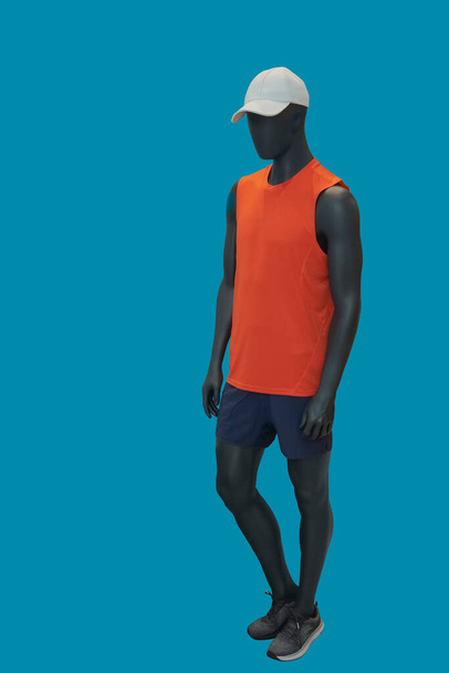 Full length image of a female display mannequin dressed in sportswear isolated on blue background - Foto, immagini