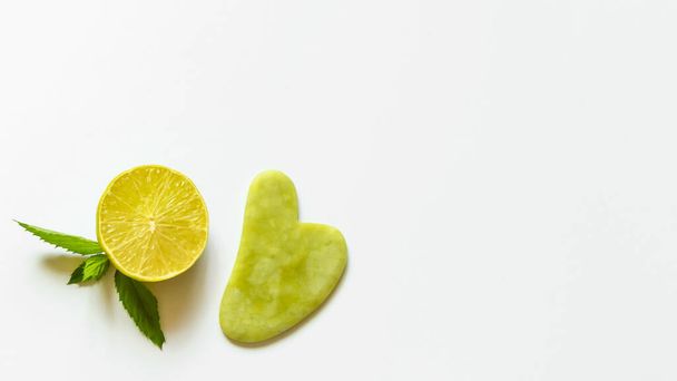 Juicy Green Lime Cut Green Stone Facial Massager Gua Sha copy Space - Photo, Image