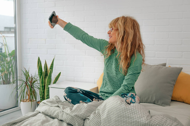 woman at home with mobile phone recording  - Photo, Image