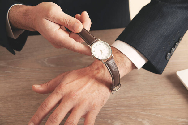 young business man hand watch  in office - Foto, Bild