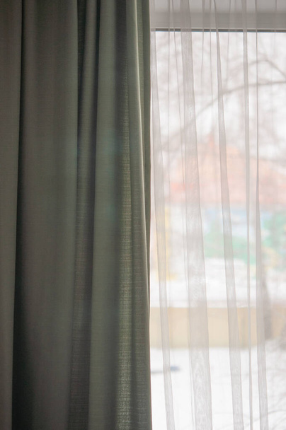 Curtain with tulle on the window. The interior of the room with draped curtains. - Photo, Image