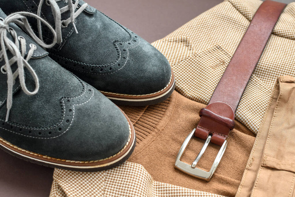 Men green suede derby shoes combined with light beige blazer, sweater, chino pants and belt. Selective focus. - Φωτογραφία, εικόνα