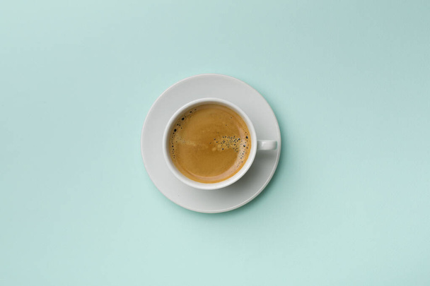 Cup of delicious coffee on color background, top view. - Photo, Image