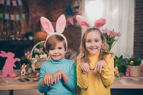 Photo of two funky positive preteen people arms make bunny paws good mood festive atmosphere indoors - Φωτογραφία, εικόνα