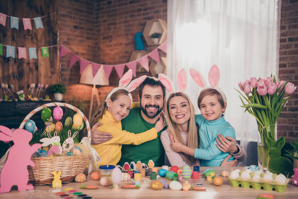 Portrait of attractive funny full big cheerful family having fun coloring eggs creative art hugging cuddling indoors - Photo, image