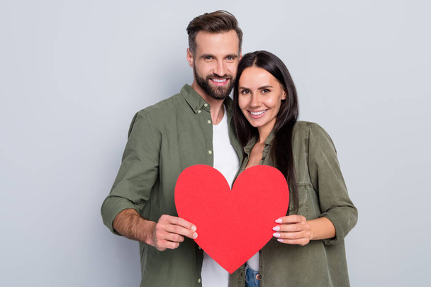 Portrait of attractive sweet tender cheerful couple hugging holding heart form romance isolated over grey pastel color background - Fotografie, Obrázek