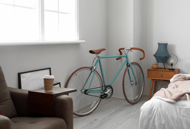 Bicycle near light wall in light bedroom - Fotó, kép
