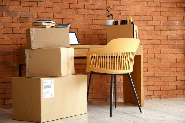 Boîtes en carton avec effets personnels et table au bureau le jour du déménagement - Photo, image