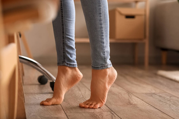 Bare feet of young woman at home, closeup - Fotó, kép
