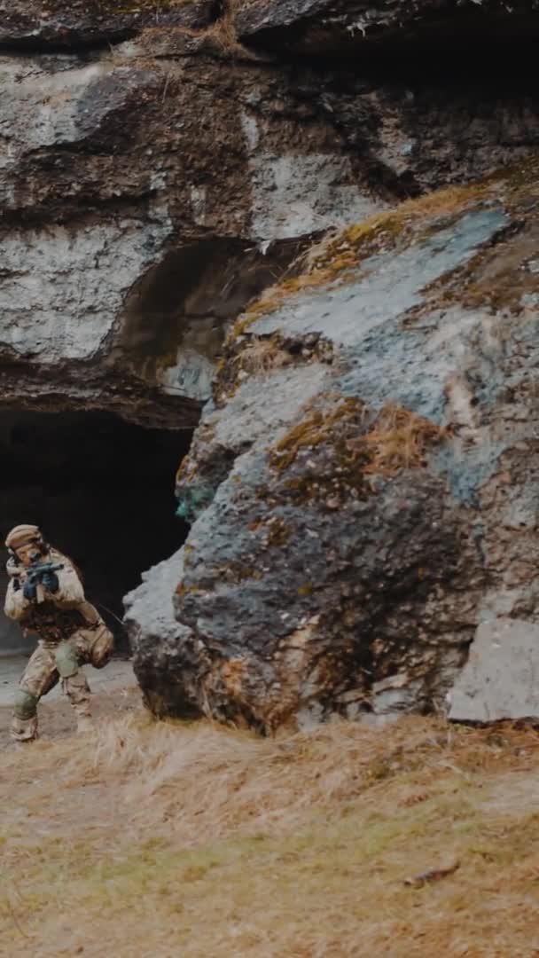 Vertical Shot - Vigilant soldiers entering cave territory of rebels  - Footage, Video