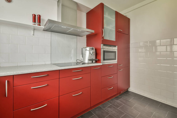 Small kitchen with red furniture - Foto, Imagem