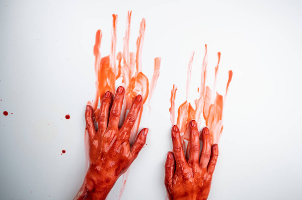 Female hands in blood on a white background.  - Photo, Image