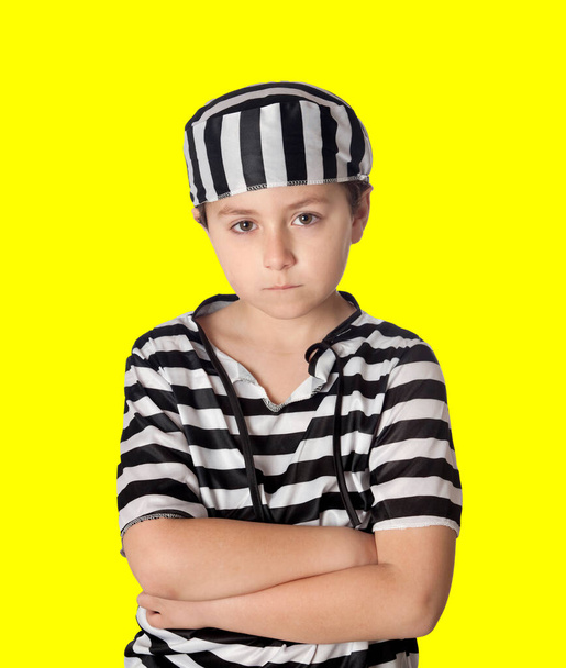 Sad prisoner wearing a striped uniform isolated on a yellow background - Photo, Image
