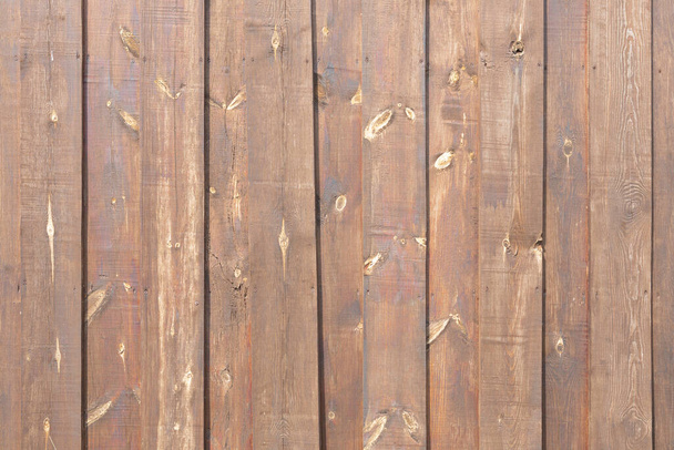 wooden wall of brown boards, vertically arranged, close-up shot - Foto, Bild