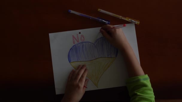 Ukrainian flag and a heart in yellow and blue color. Child draws a heart on the blackboard - Footage, Video