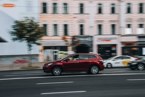 Ukraine, Kyiv - 2 August 2021: Red MAZDA CX-7 car moving on the street. Editorial - Photo, Image