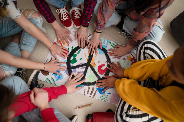 Top view of students making a poster of peace sign at school. - Fotografie, Obrázek