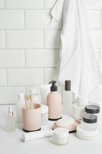 Bath accessories. Dressing table. Cosmetics and hygiene products. Spa and beauty salon. Toothbrush and soap, cream containers. - Photo, Image