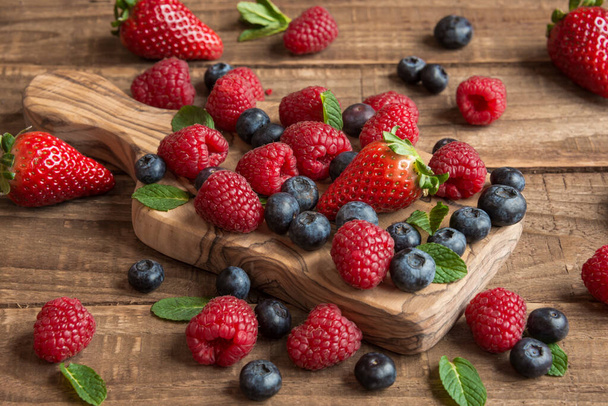 fresh berries on wooden background - Photo, Image