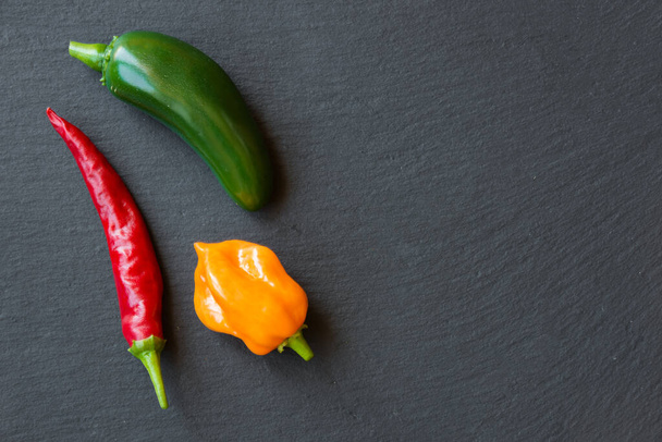 red hot pepper on a black background. top view. - 写真・画像