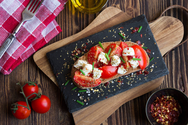 bruschetta tomaattien, mozzarellan, oliiviöljyn ja basilikan kanssa puupohjalla. - Valokuva, kuva