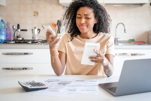 One black woman worried about home expenses - Zdjęcie, obraz