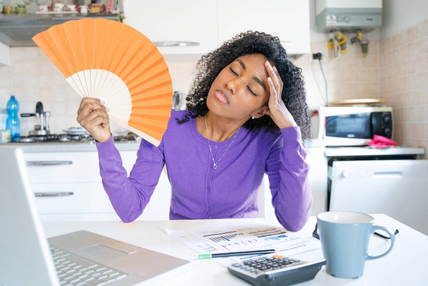 One black young woman suffering summer hot weather at home - Photo, Image