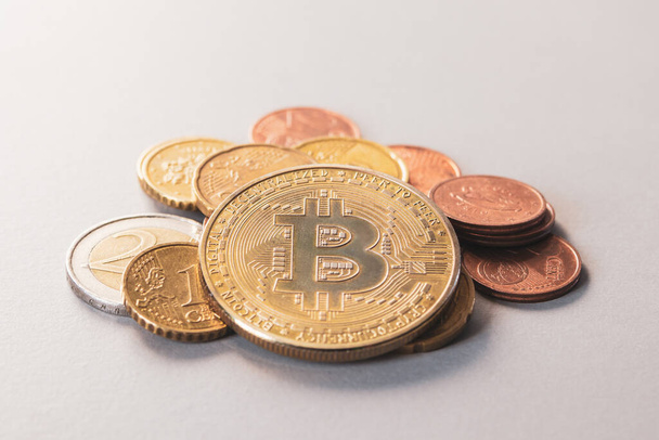 Bitkoin coin on a pile of euro cash. - Fotografie, Obrázek
